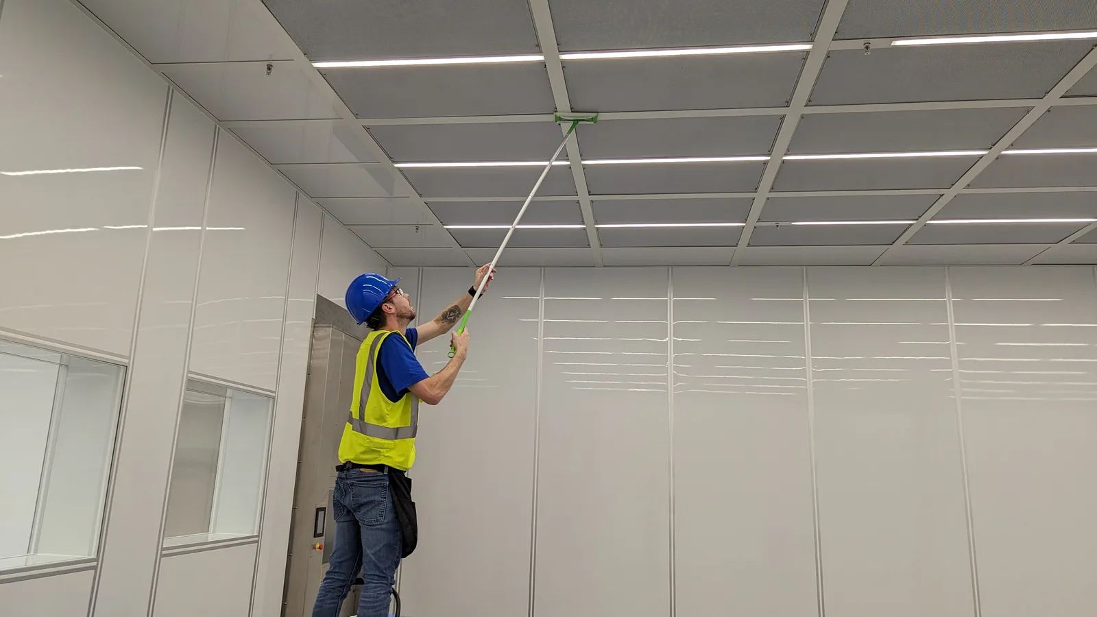 LeBlanc Cleaning technician cleaning ceiling panels in a commercial cleanroom in Mesa, AZ
